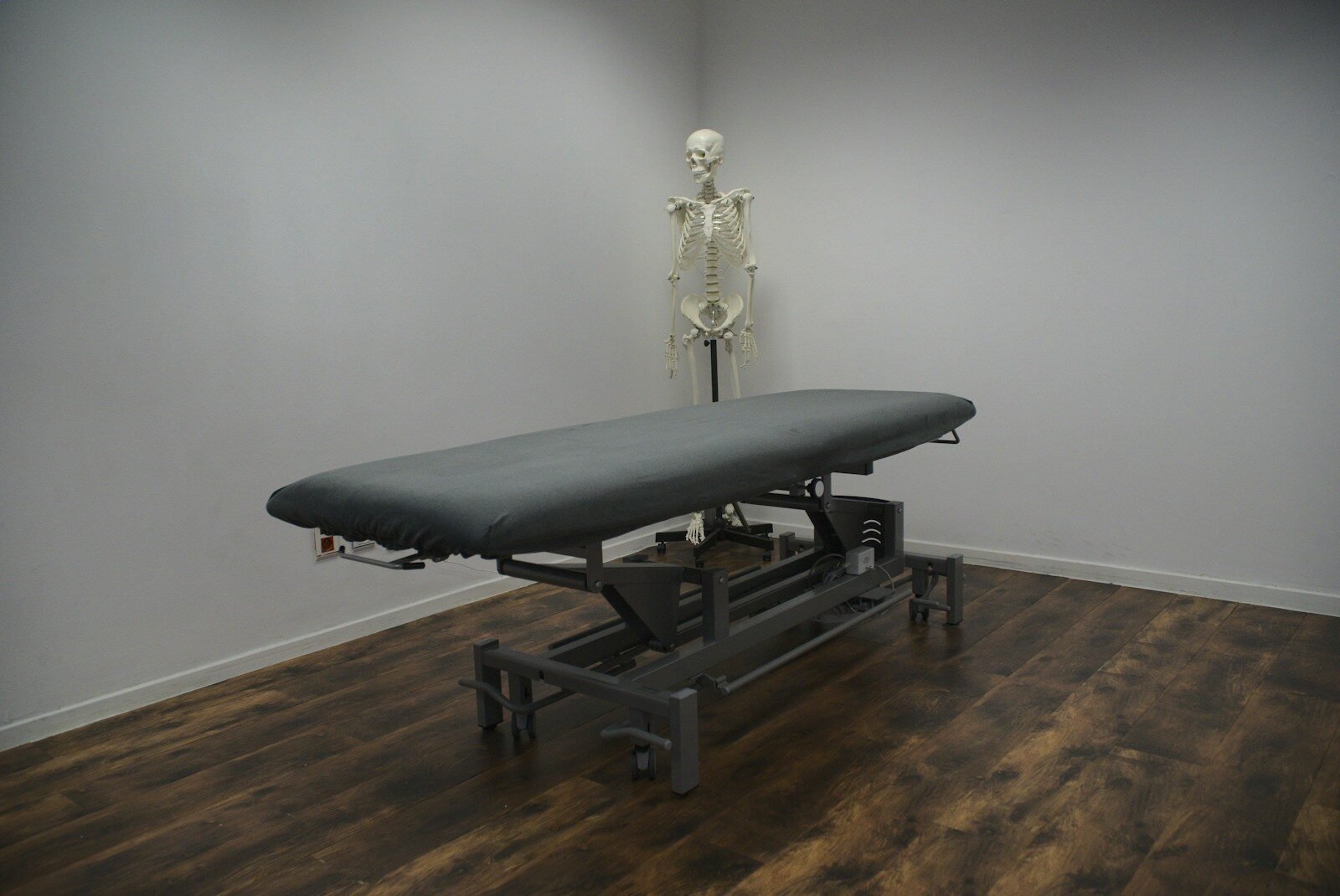 black bed frame on brown wooden parquet floor